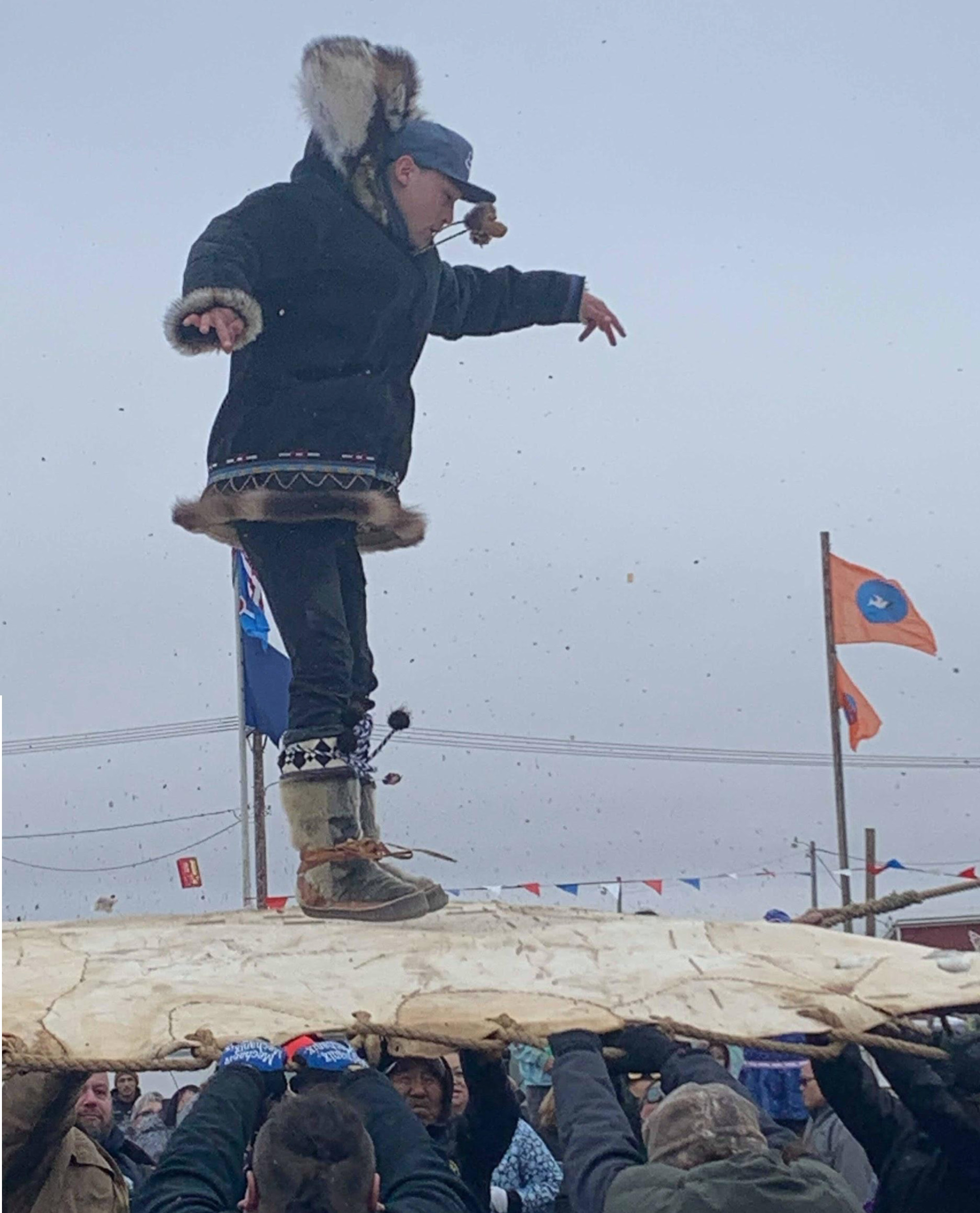 Bradley Brower, Gordon Iakyuak’s son, being tossed high in the air from a blanket made of sealskin during the Nalukataq festival, a celebration of the spring whaling hunting season. Photo: Courtesy of Gordon Ikayuak Brower