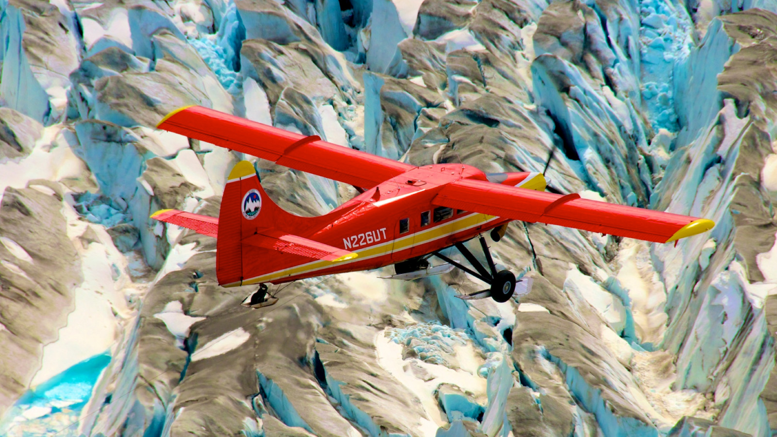 Image shows a NASA Airborne Campaign observing climate impacts in the arctic. This red plane is a DHC-3 Otter, the plane flown in NASA’s Operation IceBridge-Alaska surveys of mountain glaciers in Alaska. Over the past few decades, average global temperatures have been on the rise, and this warming is happening two to three times faster in the Arctic. Credit: Chris Larsen, University of Alaska-Fairbanks NASA Goddard
