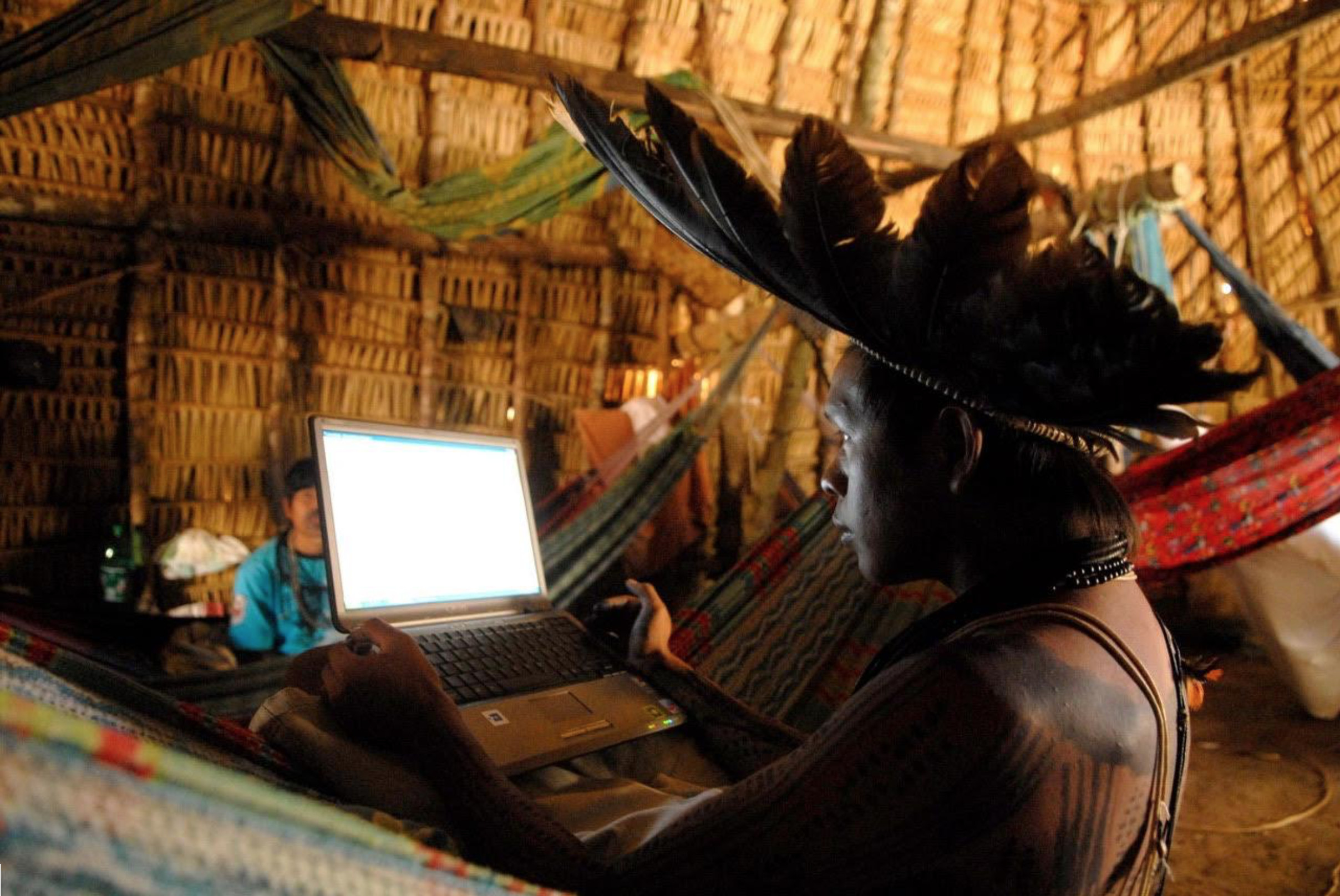 Members from the Surui Paiter Tribe in the Brazilian Amazon access the Internet in their remote community. Credit: Surui Metareila Association Archives. Courtesy of Vasco M. van Roosmalen from ECAM.