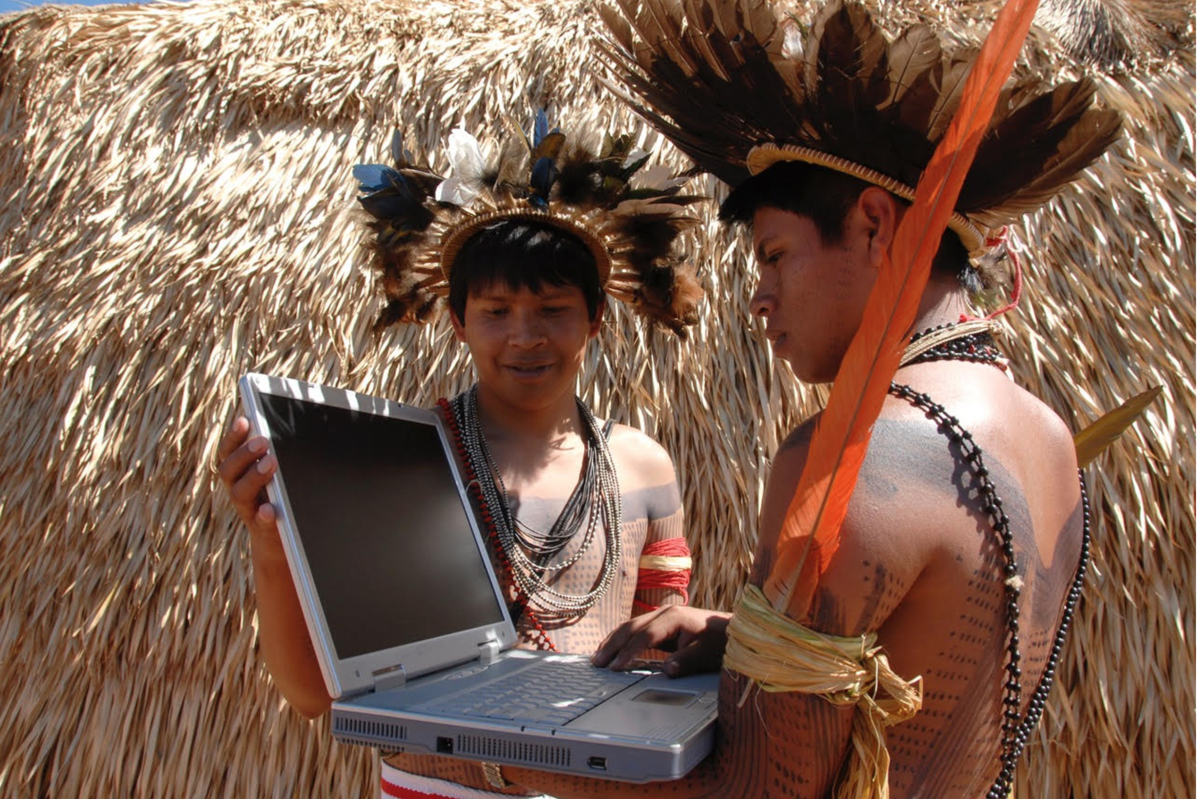 Picture shows members from the Surui Paiter Tribe in the Brazilian Amazon as they access the Internet in their remote community. Credit: Surui Metareila Association Archives. Courtesy of Vasco M. van Roosmalen from ECAM.
